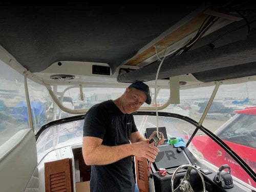 Nigel Louw installing marine electronics on a boat in Tauranga